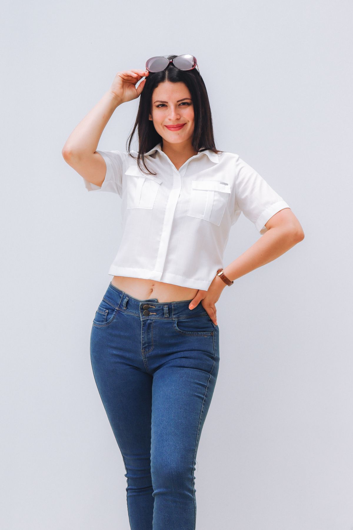 A white short-sleeved shirt worn with blue jeans