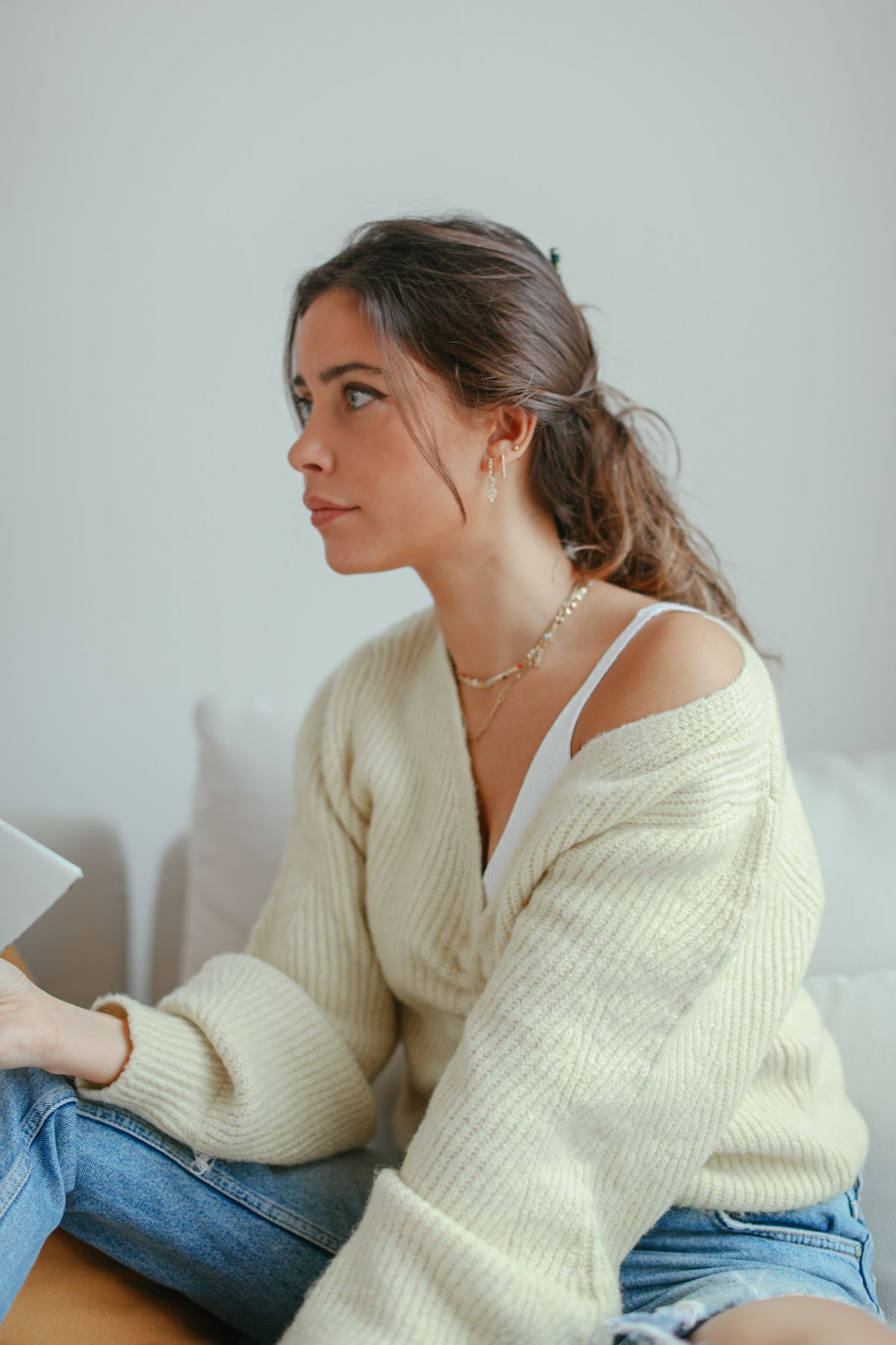 A cream cardigan layered over a white top