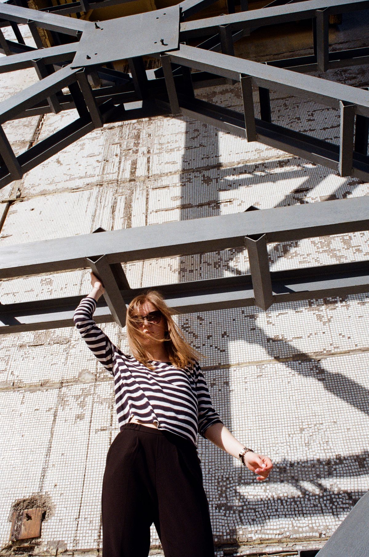 A striped top paired with dark trousers outdoors
