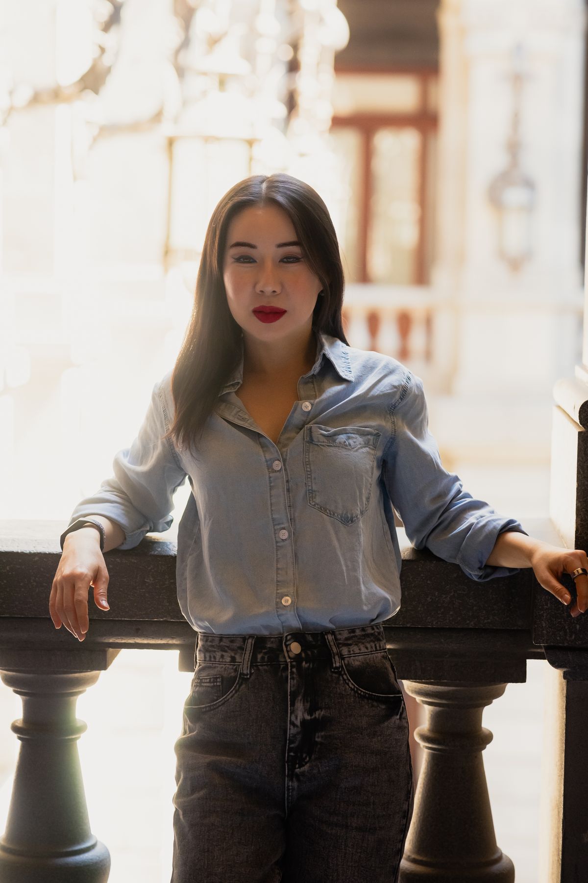 A blue denim shirt tucked into dark jeans