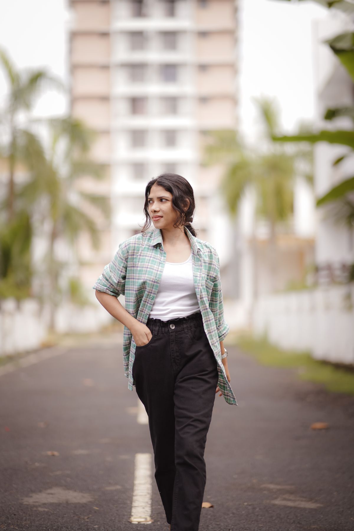 Black trousers worn with a white top and open shirt