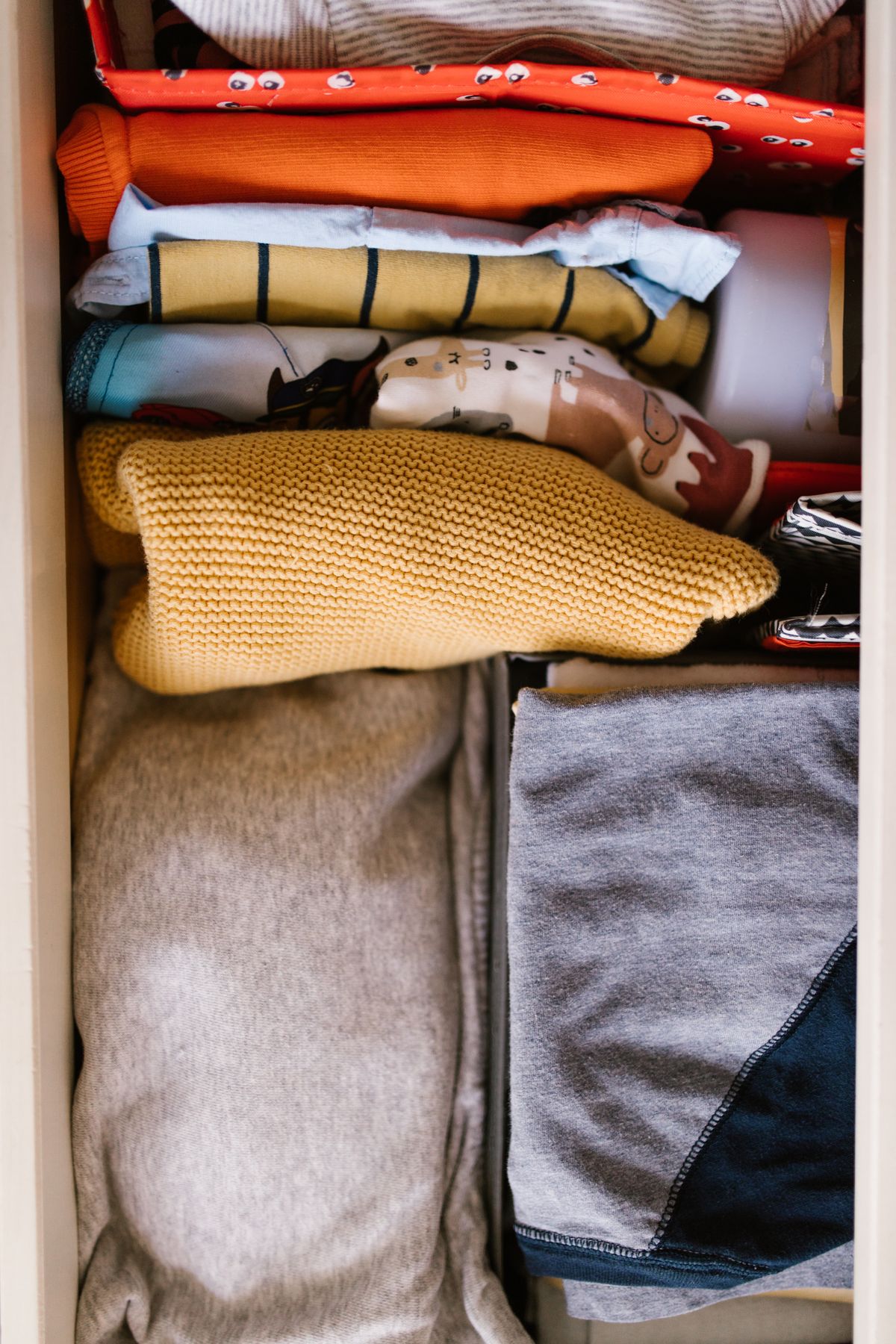 Clothes folded into rows inside a drawer