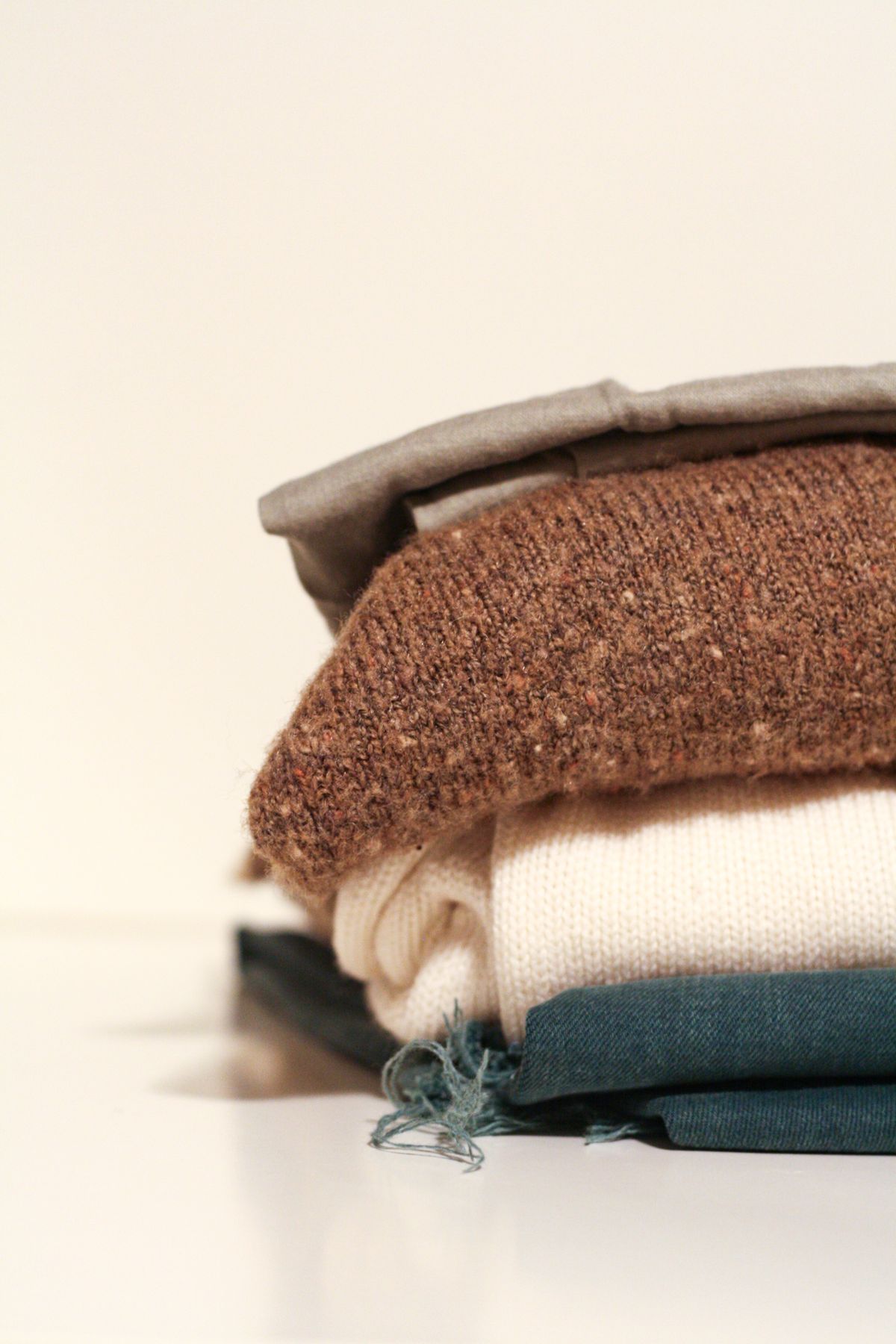 A low stack of folded textured jumpers