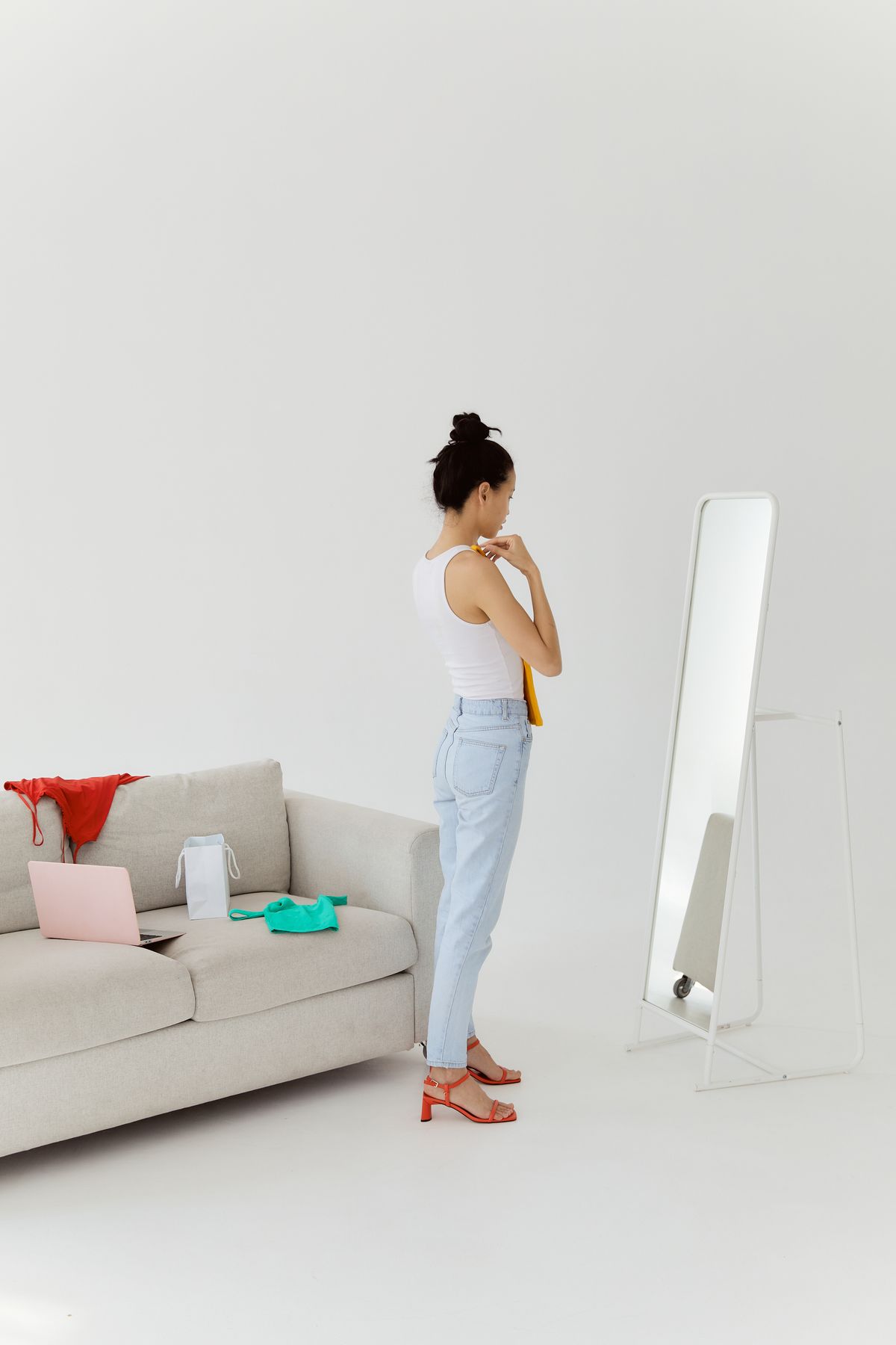 A woman checking the fit of an outfit in a mirror