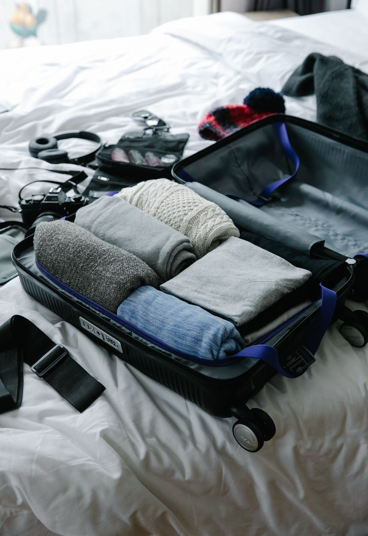 Travel clothes arranged inside an open suitcase