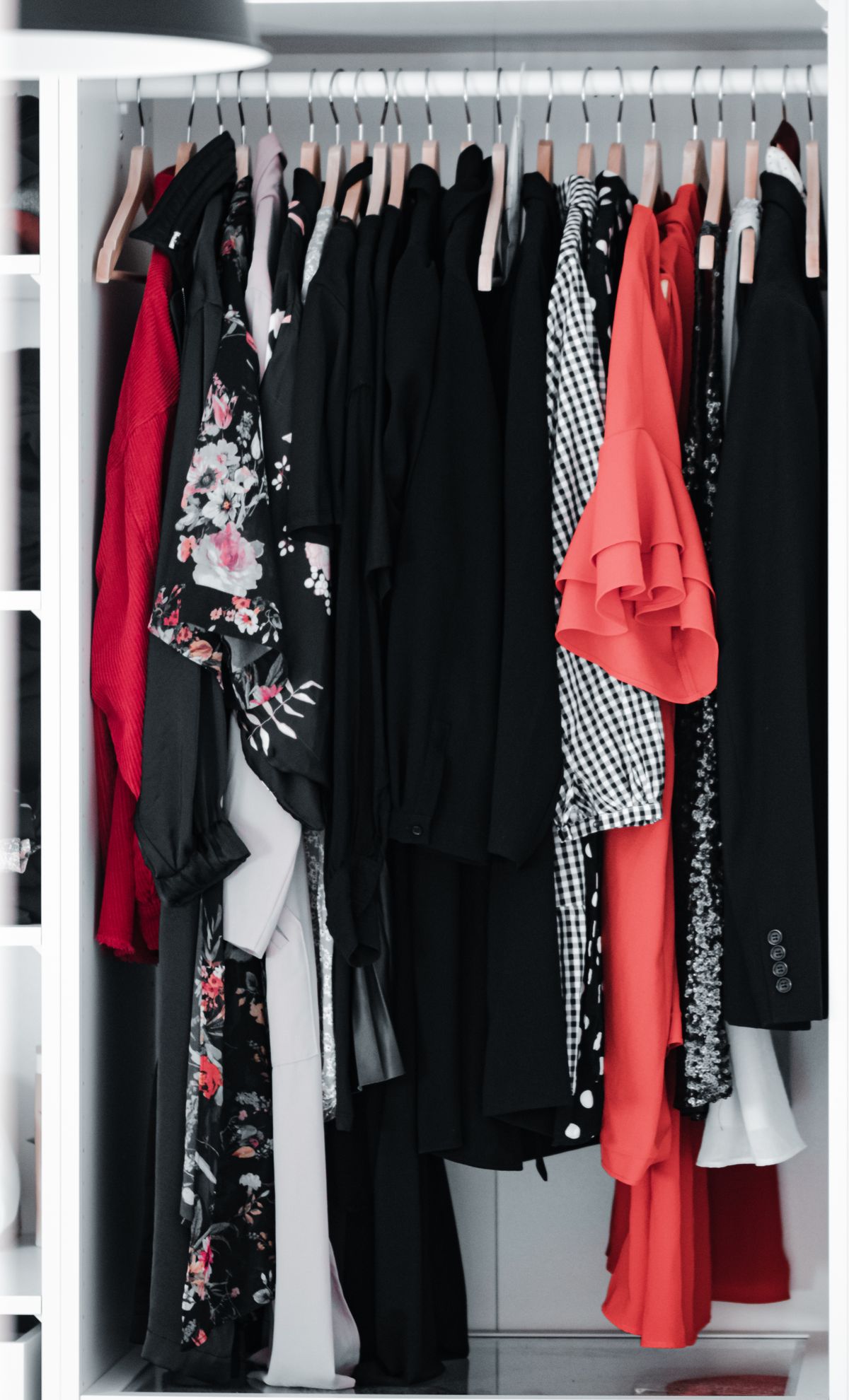 Different styles of clothes sharing a wardrobe rail