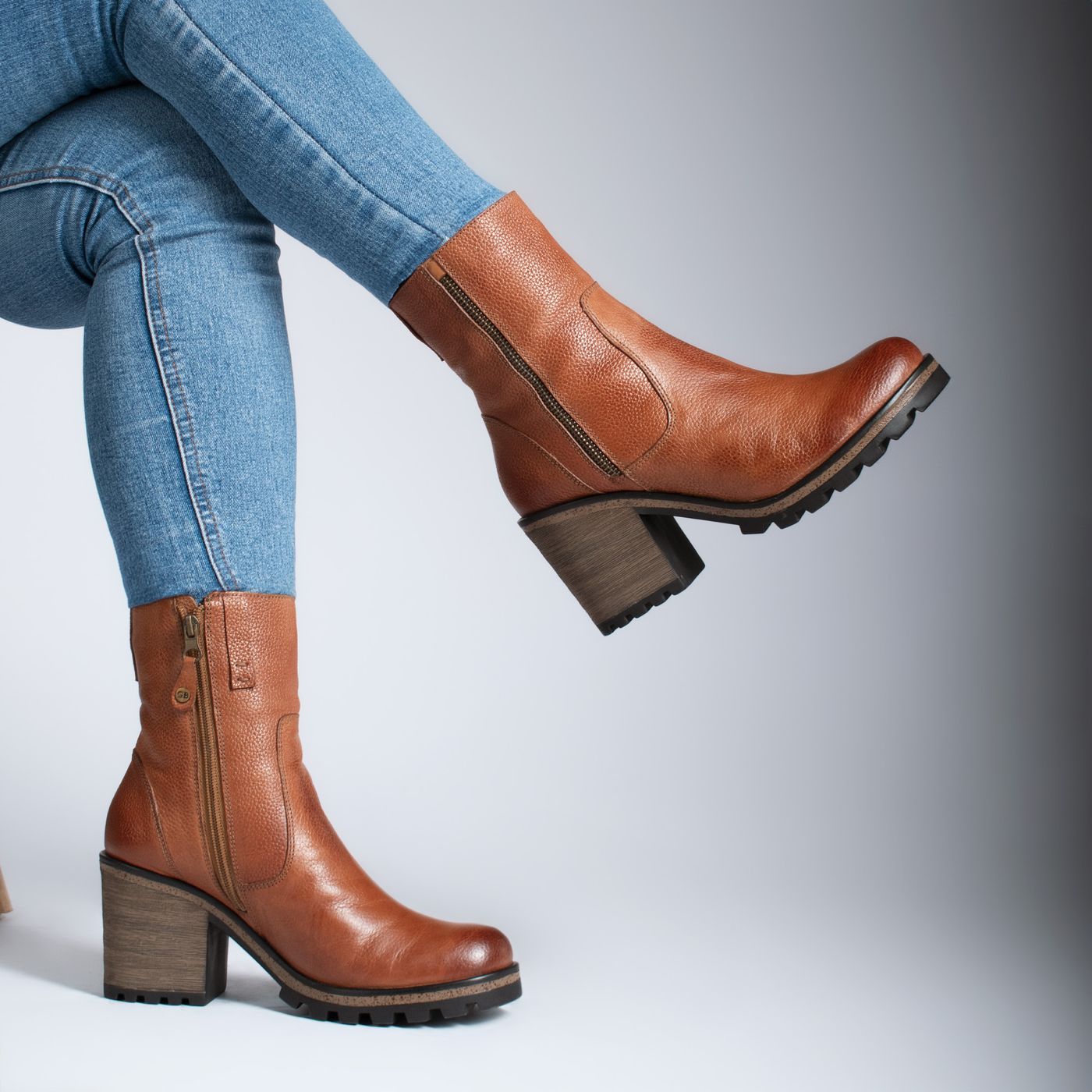Brown ankle boots worn with fitted blue jeans