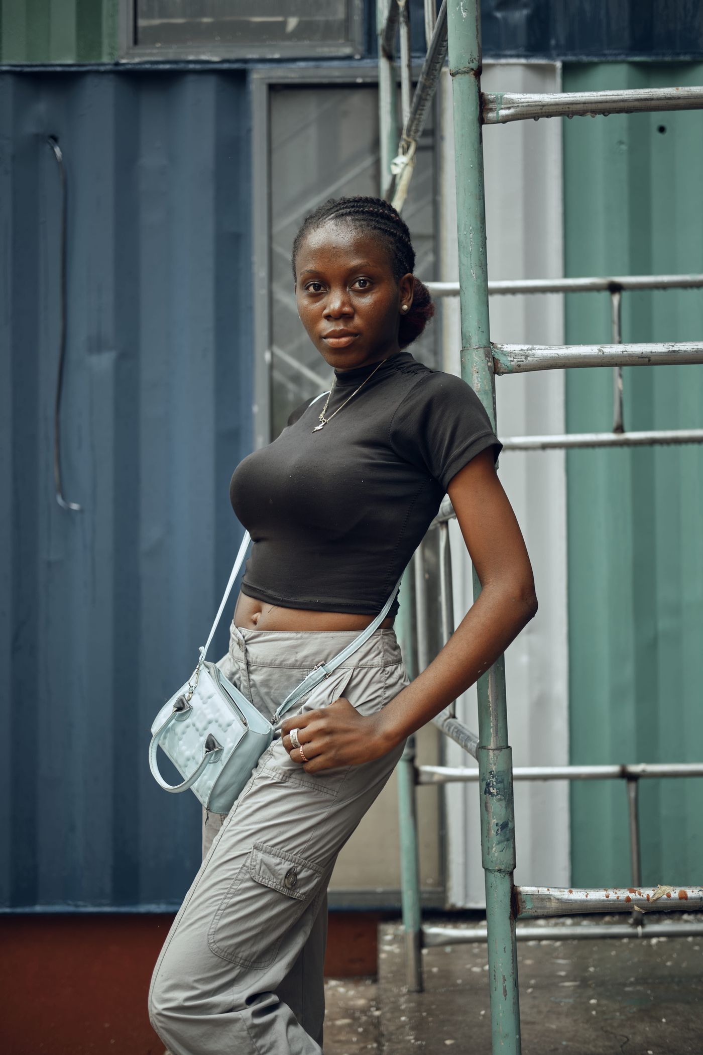 A small crossbody bag worn across a dark top