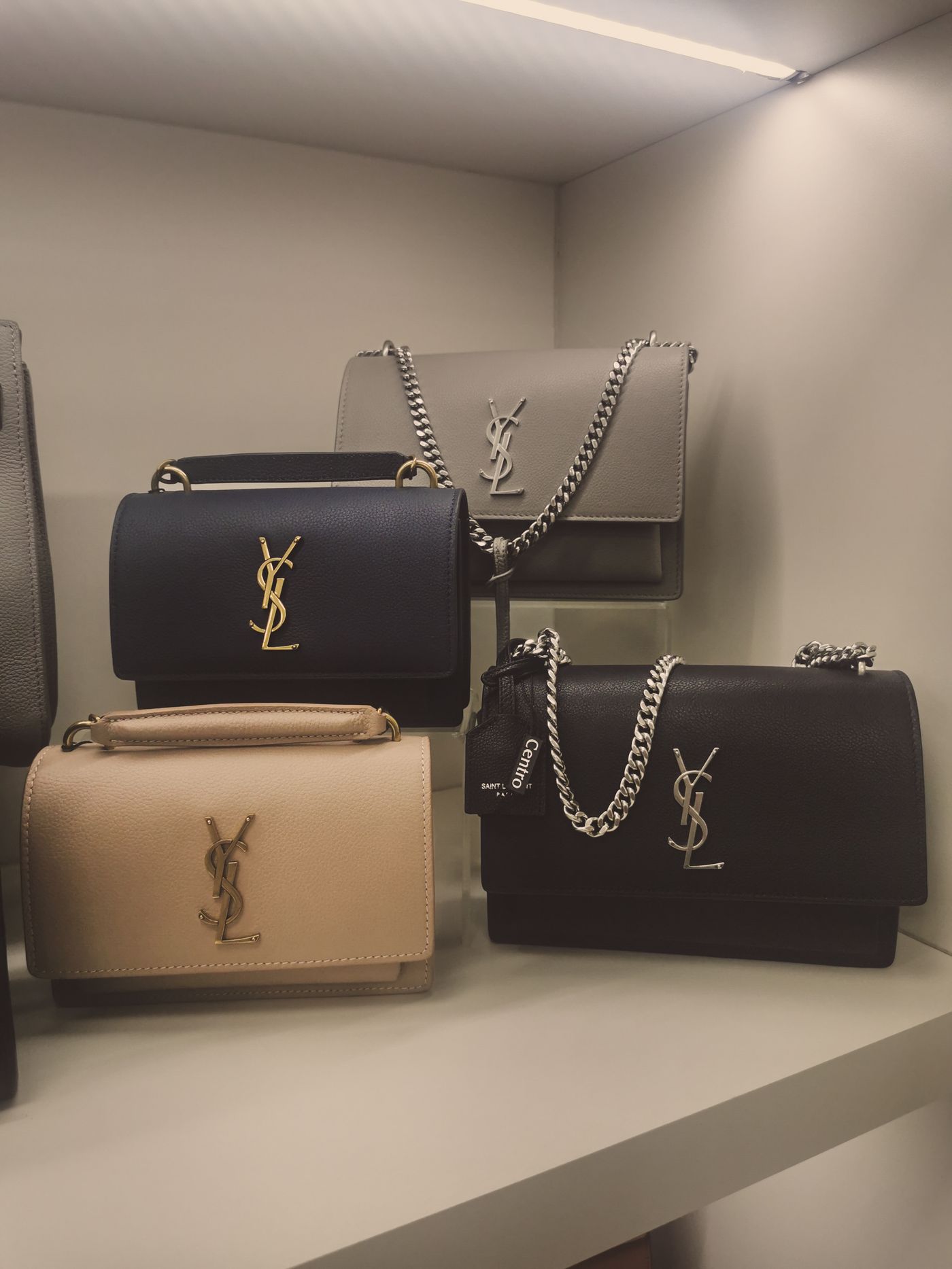 Handbags standing upright on shelves