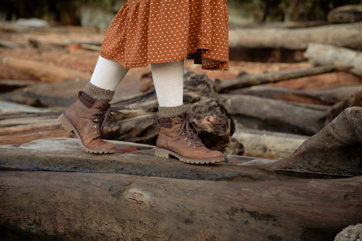 Lace-up boots beneath a skirt on a woodland path