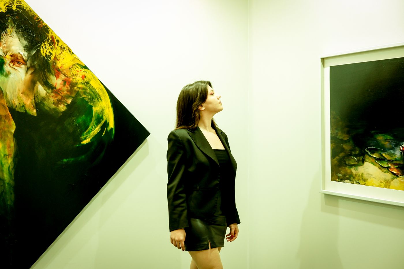 A woman in a dark outfit visiting an art gallery