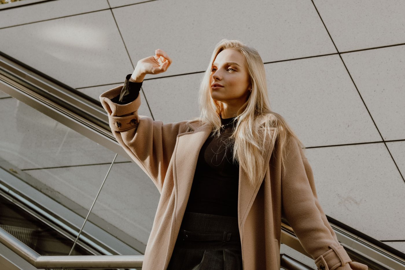 An open wool coat worn over a dark knit