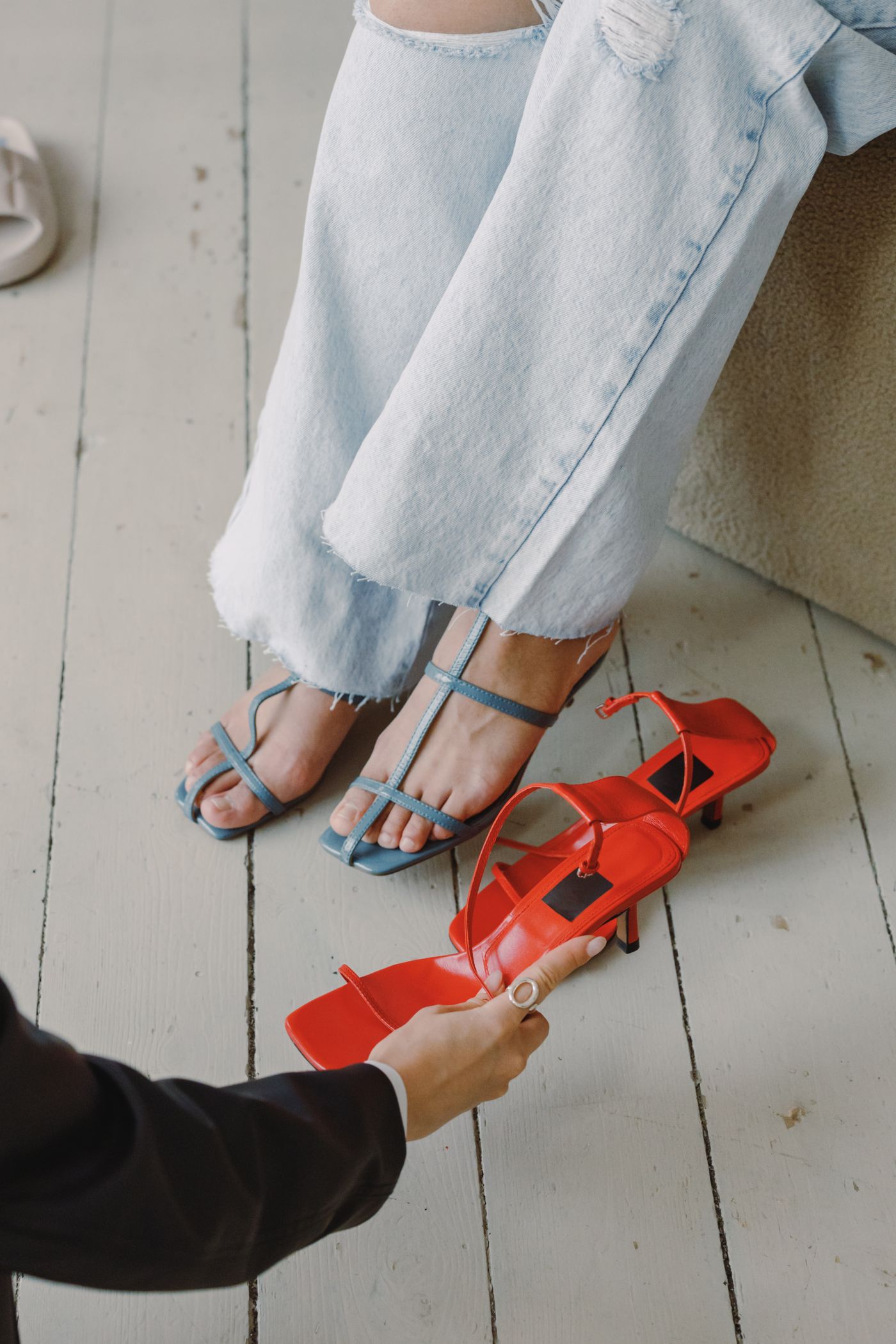 A woman trying shoes while comparing another pair